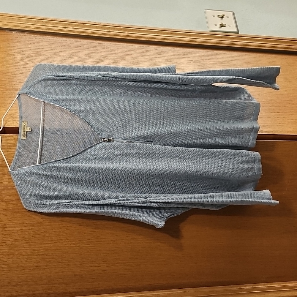 Women's lightweight sweater with half zip up front.